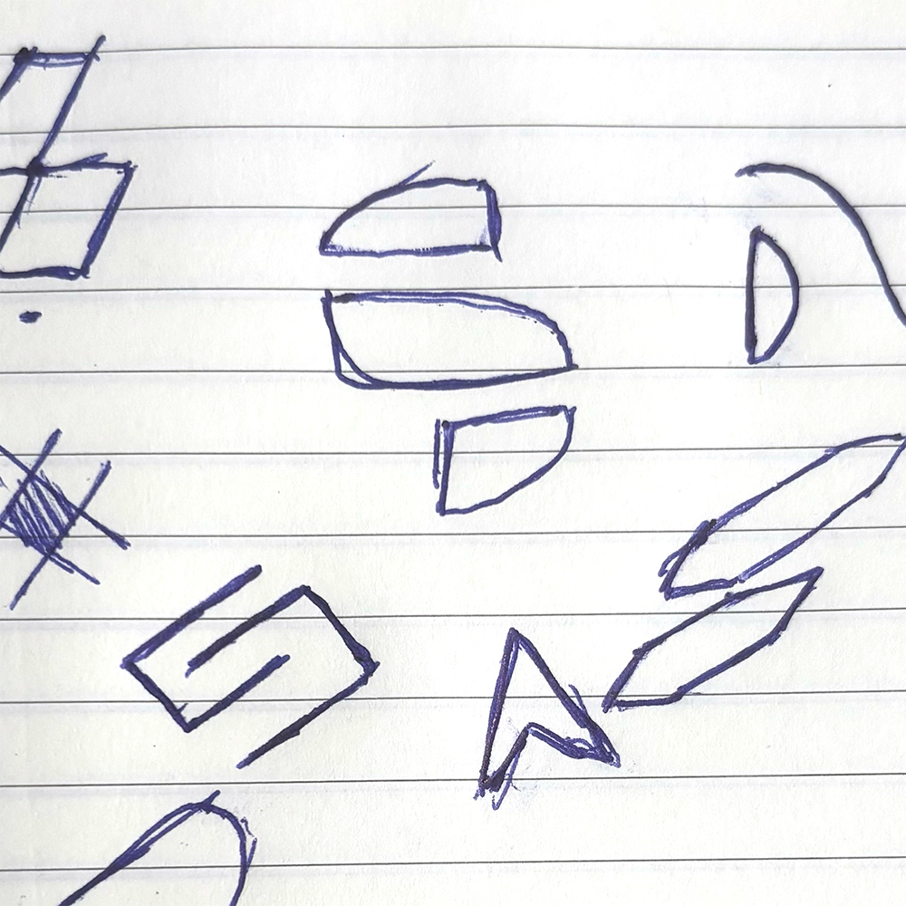 A photo of a notebook page with hand-drawn logo sketches in blue ink. The central sketch features a segmented 